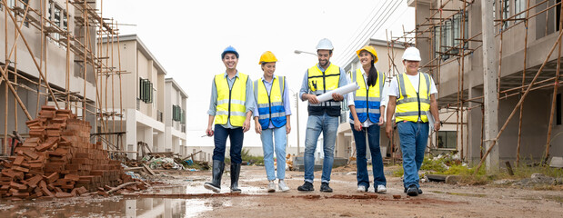 Engineer and foreman team celebrate residential project development success with smile at...