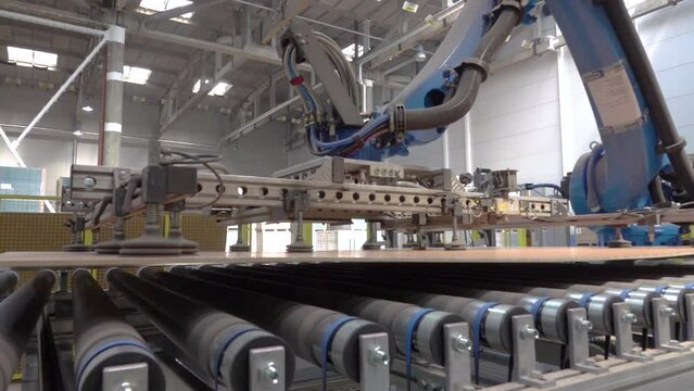 Modernized woodworking manufacture. Robotic equipment composing wooden panels inside the parquet floor factory.