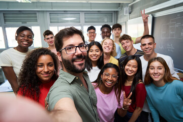 Happy selfie of young group of Erasmus students taking a photo with their teacher in the classroom. - Powered by Adobe