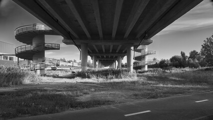 A view under the big bridge in black and white
