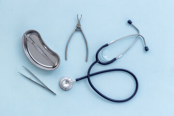 Medical equipment tools instruments in steel tray at doctor desk