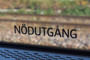sign in swedish train that says "emergency exit" in swedish