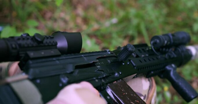 the hands of a soldier insert a magazine with cartridges into a weapon, an AK-74 Kalashnikov assault rifle and reload. close-up