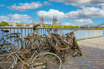 Cologne, Germany - July 9. 2022: Pile many old muddy rusty bicycles thrown into the rhine and then salvaged (focus on center)