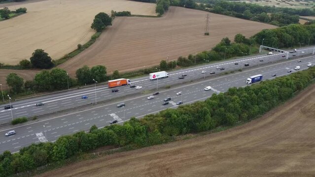 Aerial View of British Motorways With Fast Moving Traffic at Peak Time. M1 J11 and  J7 Motorways Junction Interchange. Time Lapse Shot captured on 7th Sep 2022