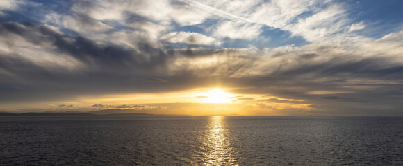 Cloudy Cloudscape during sunny summer Day on the West Coast of Pacific Ocean. British Columbia, Canada. Sunset Sky