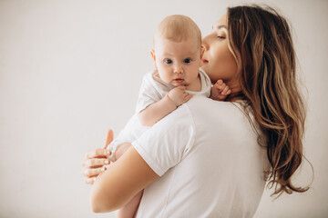 Family mother and little baby, beautiful and happy together, portrait on white background