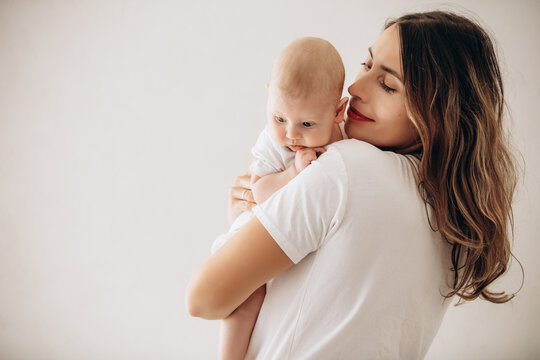 Family mother and little baby, beautiful and happy together, portrait on white background