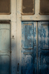 detail of an antique and weathered blue painted door