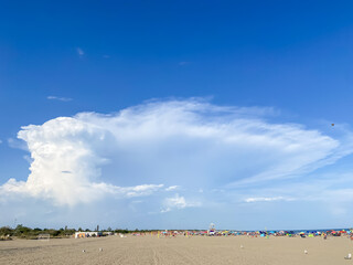 Seashore landscape. Summer holiday destination in Italy. Sandy beach in sunlight.