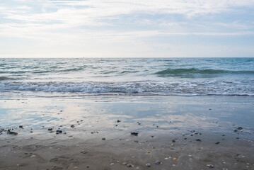 Seashore landscape. Summer holiday destination in Italy. Sandy beach in sunlight.