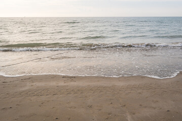 Seashore landscape. Summer holiday destination in Italy. Sandy beach in sunlight.