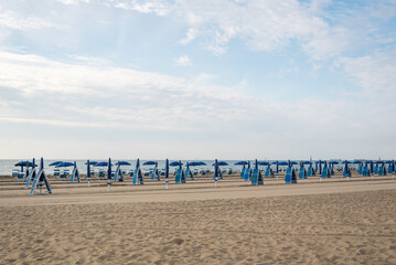 Seashore landscape. Summer holiday destination in Italy. Sandy beach in sunlight.