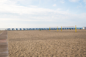 Seashore landscape. Summer holiday destination in Italy. Sandy beach in sunlight.
