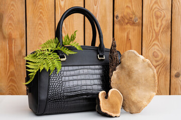 Concept of Mushroom leather - woman handbag and brown tree mushrooms. Sustainable textile made from...