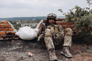 Fototapeta premium Portrait of a Ukrainian soldier in his combat position. War between Ukraine and Russia.
