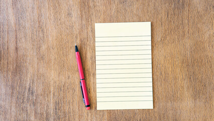 blank notebook with pen and pencil on wooden table, business concept