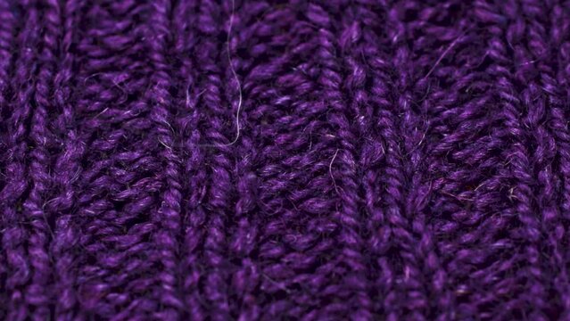Violet knitted fabric texture. Closeup detailed sweater fabric background. Soft woolen textile pattern for winter fashion background