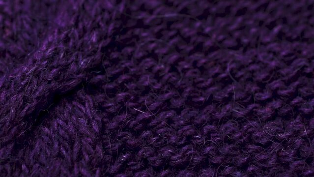 Violet knitted fabric texture. Closeup detailed sweater fabric background. Soft woolen textile pattern for winter fashion background