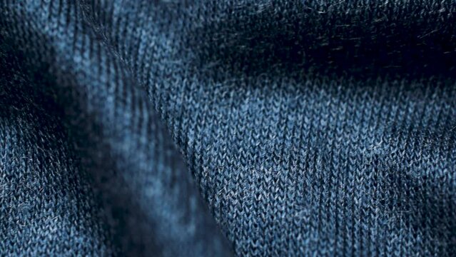 Blue knitted fabric texture. Closeup detailed sweater fabric background. Soft woolen textile pattern for winter fashion background