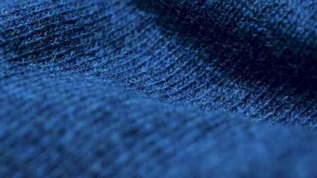 Blue knitted fabric texture. Closeup detailed sweater fabric background. Soft woolen textile pattern for winter fashion background