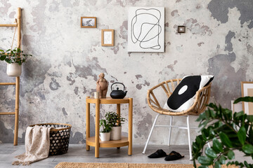 Loft style of modern apartment with design chair, pillow, carpet, basket with plaid, paintings and personal accessories. Minimalist home decor. Template. Grunge concrete wall.	