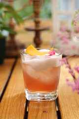 Whisky sour cocktail with foam. Classic drink with whiskey, bourbon, lemon juice, sugar, on a wooden table.