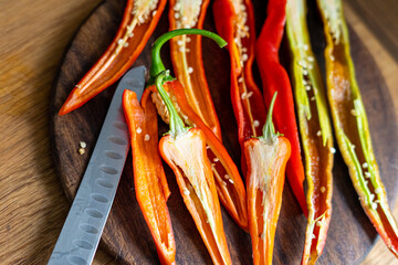 cut pods of red hot pepper on a wooden board