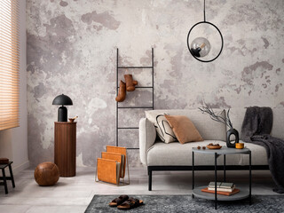 Loft style of modern apartment with grey design sofa, black coffee table, black ladder, pedant...