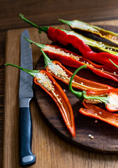 cut pods of red hot pepper on a wooden board