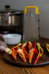 cut pods of red hot pepper on a wooden board