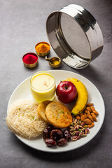 Sargi - pre-dawn meal for karwa chauth or karva chauth puja served with Chalni or strainer and diya
