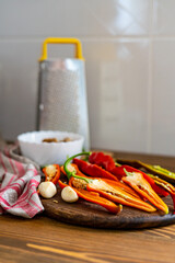 cut pods of red hot pepper on a wooden board