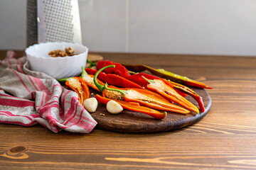 cut pods of red hot pepper on a wooden board