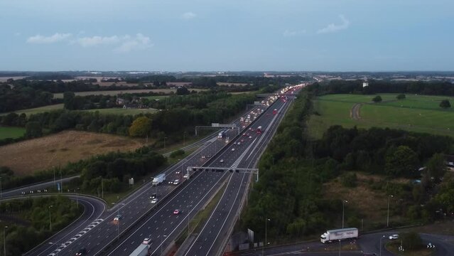 Aerial View of British Motorways With Fast Moving Traffic at Peak Time. M1 J11 and  J7 Motorways Junction Interchange. Time Lapse Shot captured on 7th Sep 2022