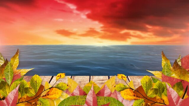 Animation of autumn leaves over sea and orange clouds in background