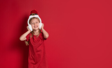 Long banner. girl in christmas clothes, surprise and laugh on a red background