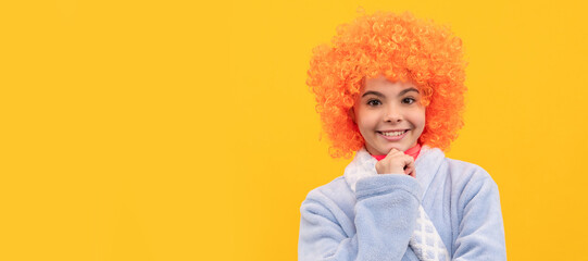 cheerful child in fancy orange wig hair wear home bathrobe, morning. Funny teenager child on party, poster banner header with copy space.