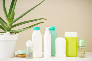 Aloe vera and composition of body care and beauty products on a beige background, close-up.
