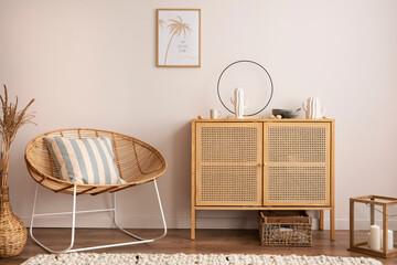 Interior design of cozy and summer living room with rattan armchair, commode, pillows, mock u...