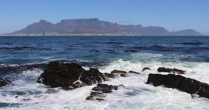 Looking across the Atlantic Ocean from Robben Island to  Cape Town city bowl with Table mountain. 