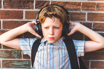 Elementary school boy outside carrying a backpack