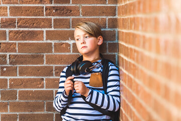 Elementary school boy outside carrying a backpack