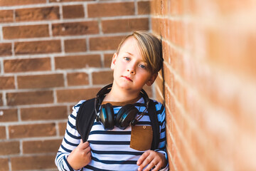 Elementary school boy outside carrying a backpack