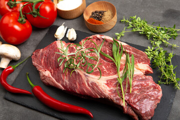 Raw beef steak on concrete table top. Healthy food concept. beef cut and spices for cooking bbq sauce