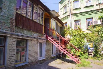 Vintage patio of historical houses with red stairs in Podil district in Kyiv, Ukraine