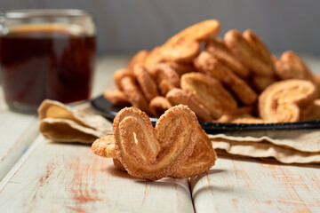 Puff pastry cookies palmier or elephant ears, caramelized and crunchy pastry with coffee. Focus...