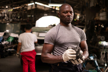 Obraz premium Portrait of a confident African American male Mechanic in the garage.