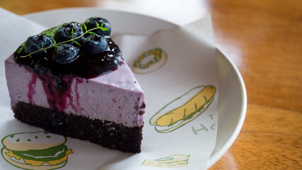 Blueberry Cheesecake cut into triangular pieces with fresh blueberries on top