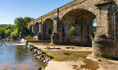 Alston Arches, a disused viaduct on the River South Tyne at Haltwhistle during a dry summer in 2022
